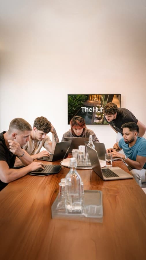 Small team working together at the coworking table at TheHub